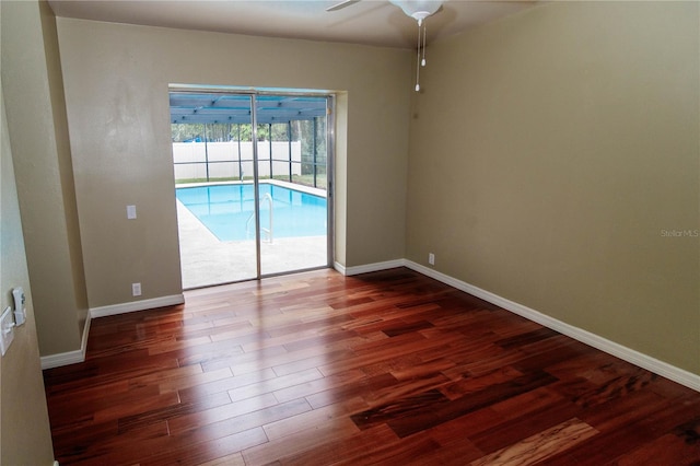 spare room with ceiling fan and dark hardwood / wood-style flooring