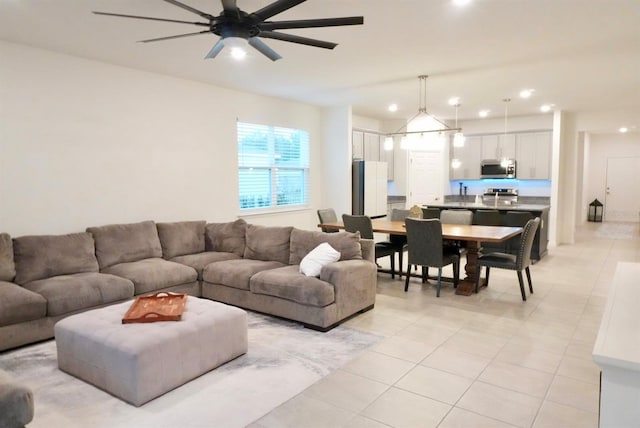 tiled living room featuring ceiling fan