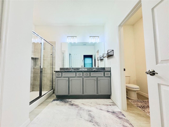 bathroom featuring vanity, an enclosed shower, and toilet