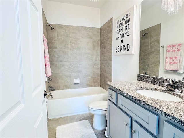 full bathroom featuring vanity, tiled shower / bath combo, tile patterned floors, and toilet