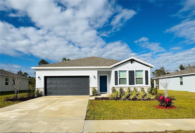 view of front of home featuring a garage and a front lawn