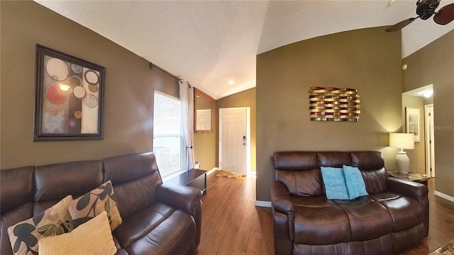 living room featuring vaulted ceiling, dark hardwood / wood-style floors, and ceiling fan