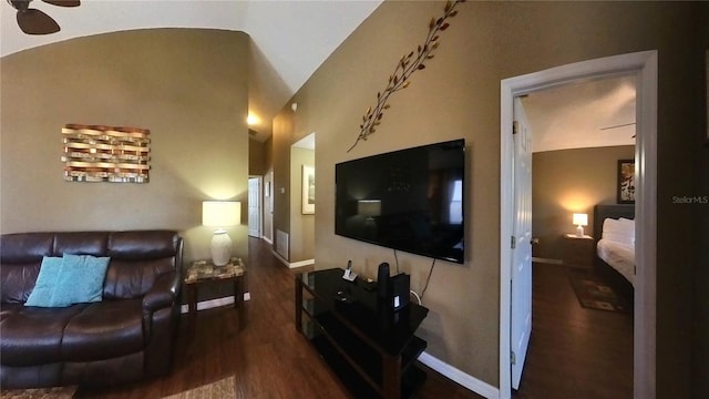 living room featuring lofted ceiling and dark wood-type flooring