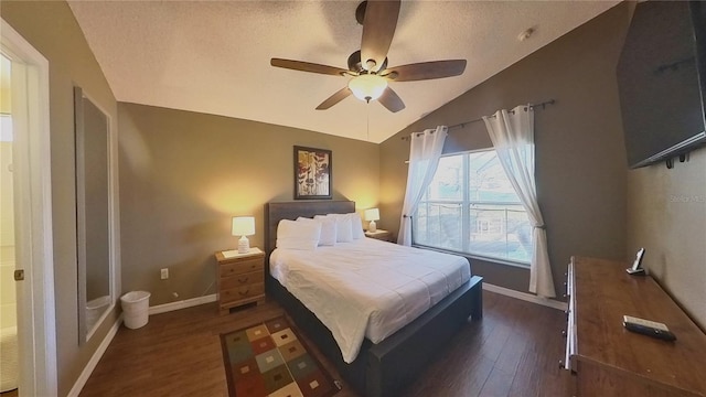 bedroom with dark hardwood / wood-style flooring, vaulted ceiling, a textured ceiling, and ceiling fan