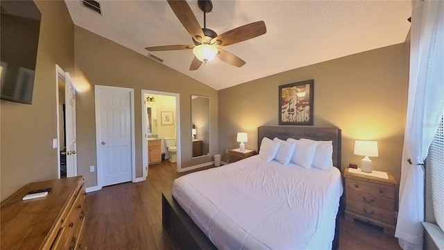 bedroom with dark wood-type flooring, ceiling fan, ensuite bathroom, and lofted ceiling