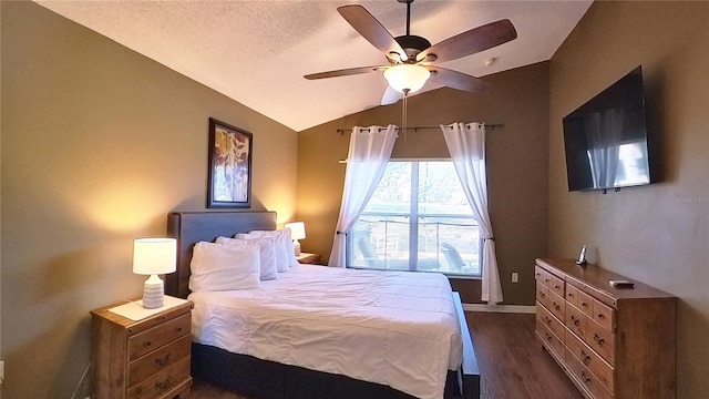 bedroom featuring lofted ceiling, dark hardwood / wood-style floors, a textured ceiling, and ceiling fan