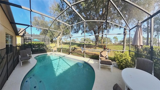 view of pool featuring a patio area and glass enclosure