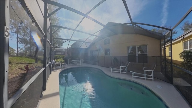 view of swimming pool with a lanai and a patio