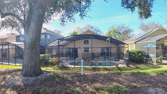 back of house with glass enclosure