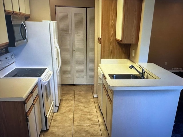 kitchen with sink, light tile patterned flooring, and white range with electric stovetop