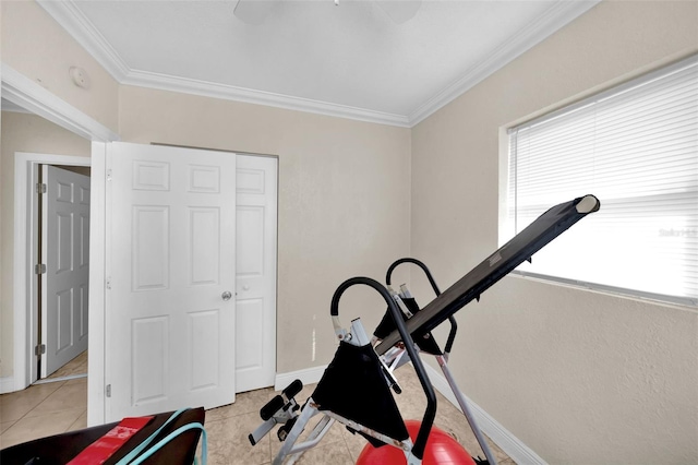 workout room featuring crown molding and light tile patterned floors