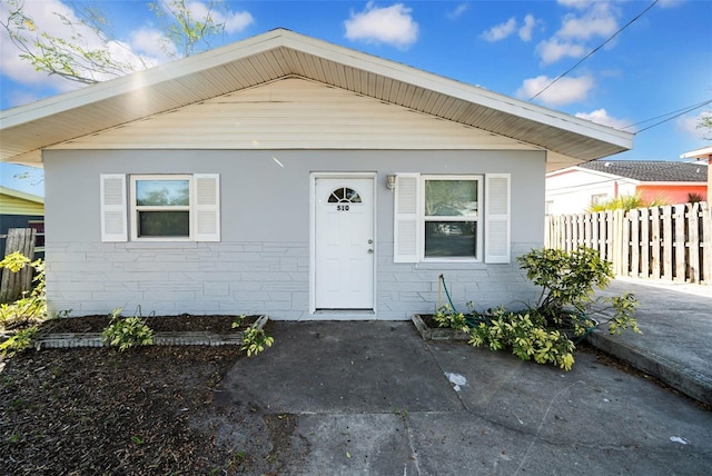 bungalow-style home with a patio