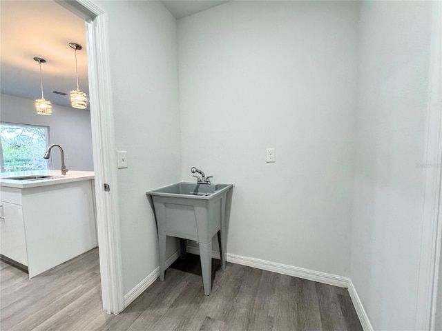 washroom featuring sink and light hardwood / wood-style flooring