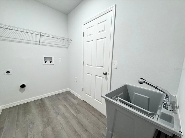 laundry area featuring electric dryer hookup, hookup for a washing machine, and wood-type flooring