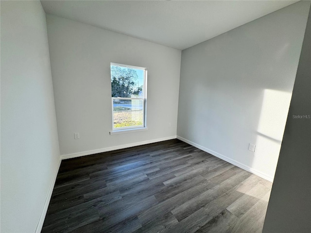 empty room with dark hardwood / wood-style floors