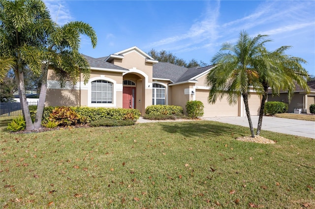 ranch-style home featuring a garage and a front lawn