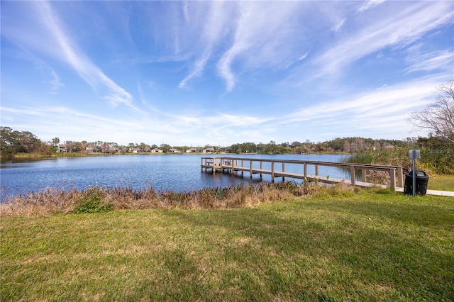 dock area with a water view and a lawn