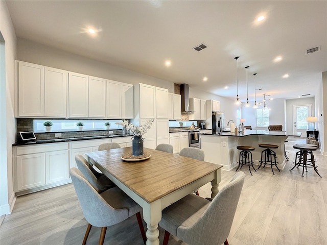 dining space featuring sink and light hardwood / wood-style flooring