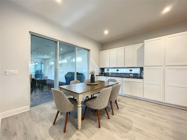 dining space with light hardwood / wood-style flooring