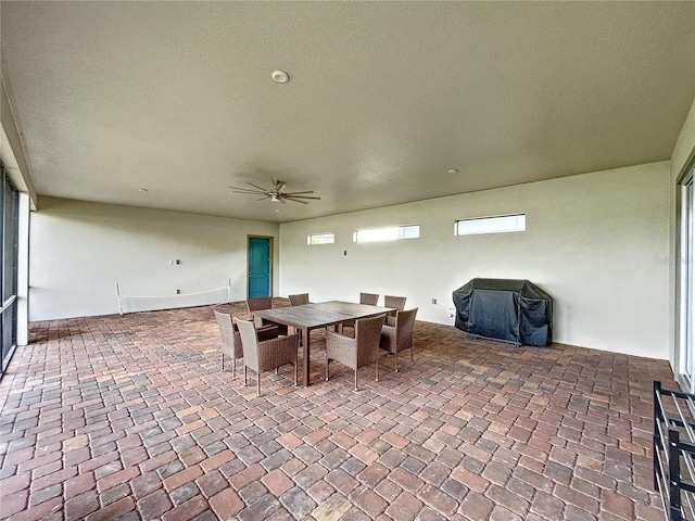 view of patio with ceiling fan and area for grilling