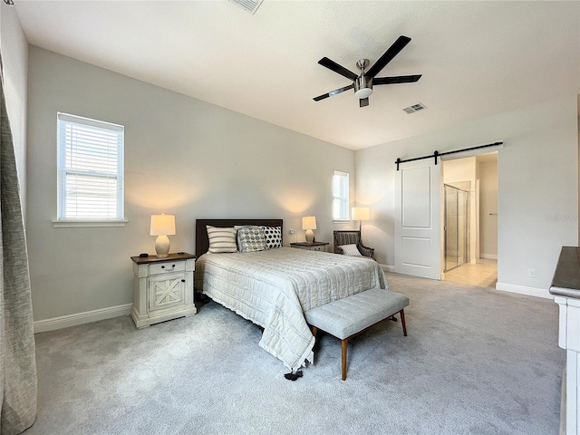 bedroom with multiple windows, a barn door, carpet, and ceiling fan