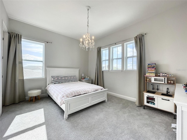 carpeted bedroom with a chandelier