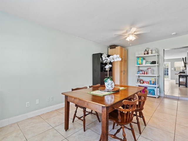 tiled dining room featuring ceiling fan