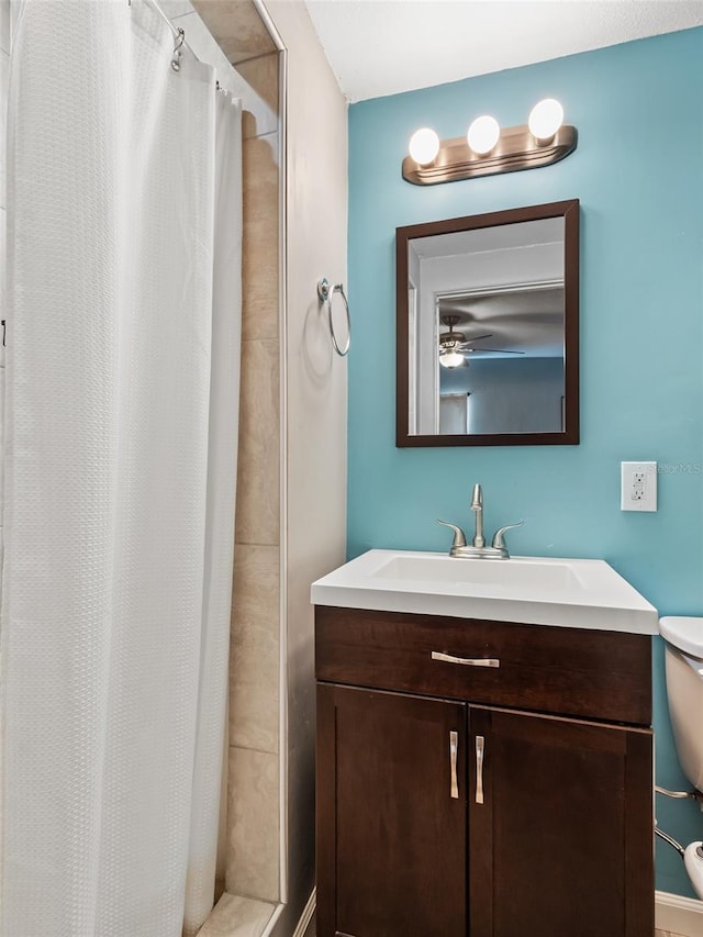 bathroom featuring vanity, toilet, and a shower with shower curtain