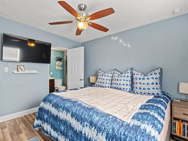 bedroom featuring hardwood / wood-style flooring, ceiling fan, and ensuite bathroom