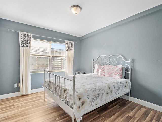 bedroom with hardwood / wood-style flooring