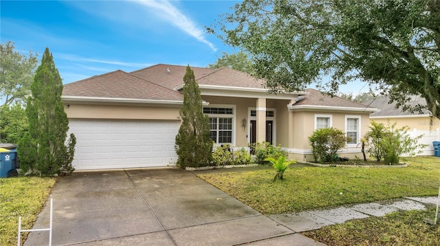 view of front of home featuring a garage and a front lawn