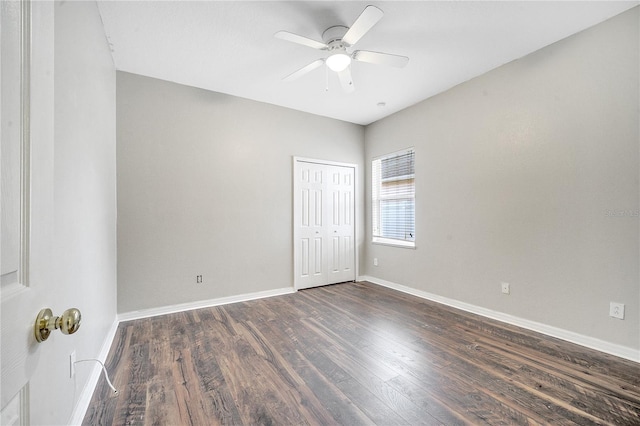 unfurnished room with ceiling fan and dark hardwood / wood-style flooring