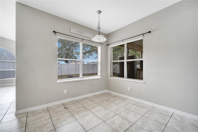 unfurnished dining area with light tile patterned flooring and plenty of natural light