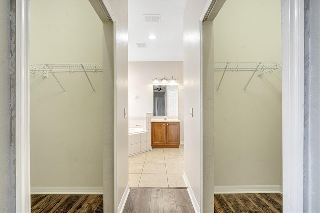 spacious closet featuring light wood-type flooring