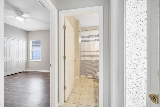 bathroom featuring ceiling fan, tile patterned floors, toilet, and a shower with shower curtain