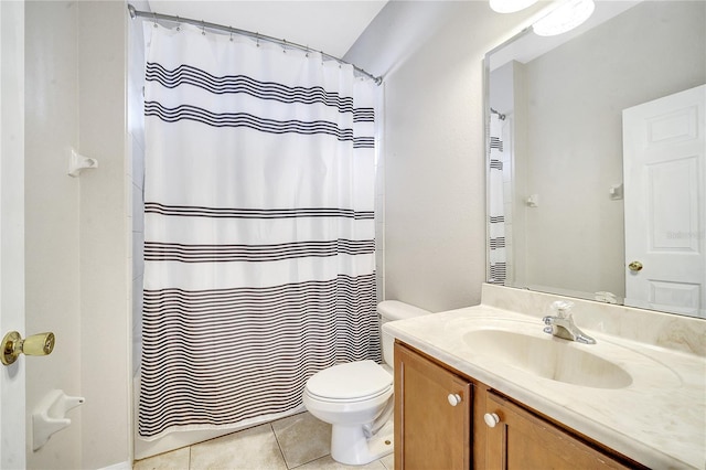 bathroom featuring vanity, toilet, and tile patterned flooring