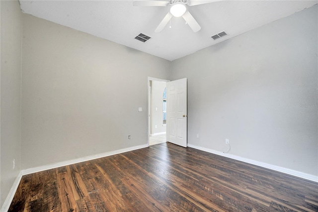 empty room with ceiling fan and dark hardwood / wood-style flooring