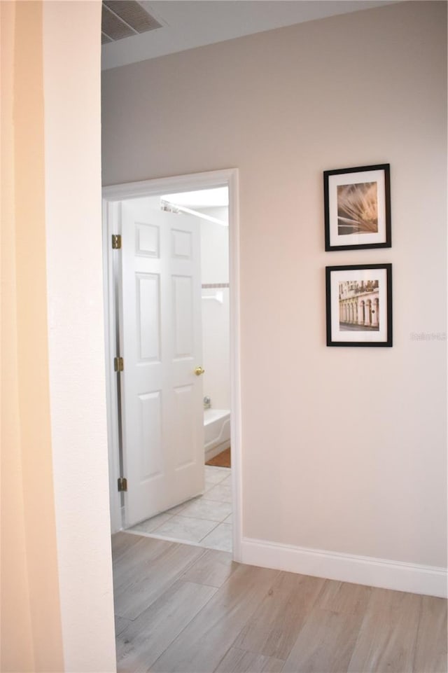 corridor with light wood-type flooring