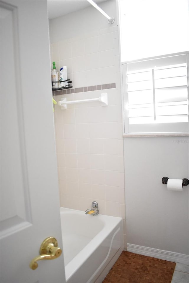 bathroom with tiled shower / bath combo and tile patterned floors