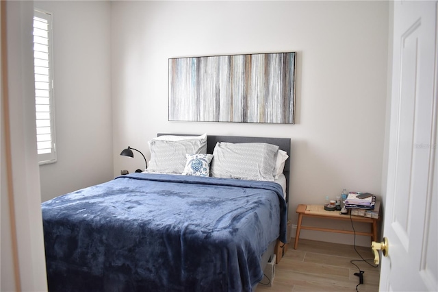 bedroom featuring multiple windows and light wood-type flooring