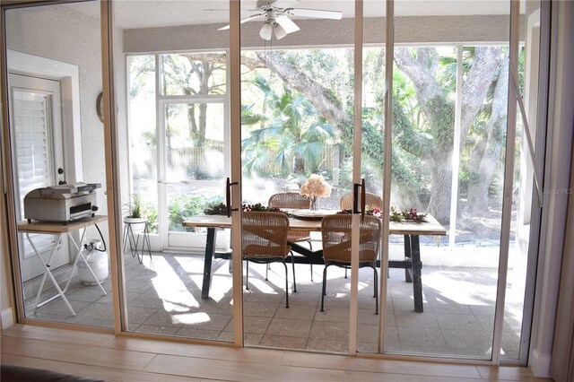 sunroom / solarium featuring a wealth of natural light and ceiling fan