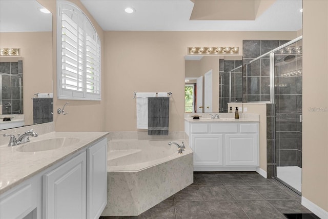 bathroom with tile patterned flooring, shower with separate bathtub, and vanity