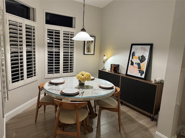 dining space with hardwood / wood-style floors