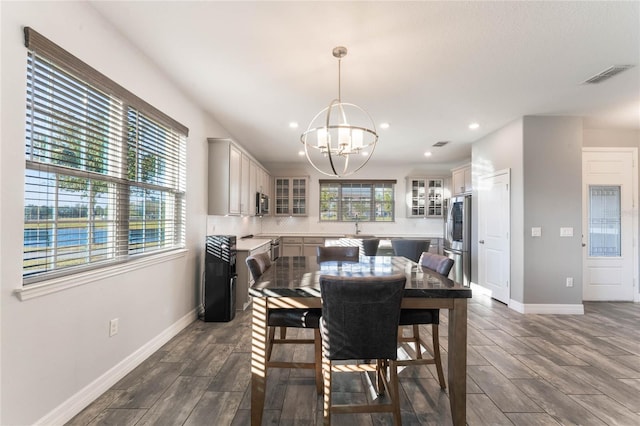 dining space with sink and a notable chandelier