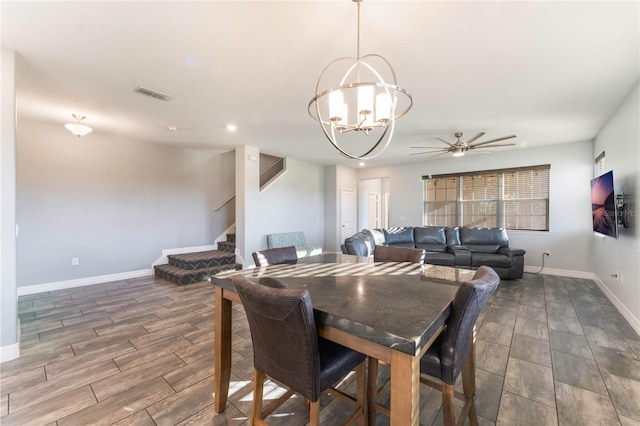 dining room with ceiling fan with notable chandelier