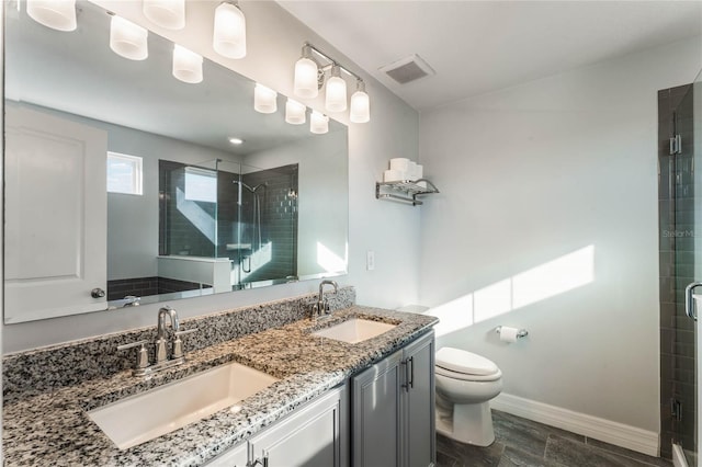 bathroom with vanity, an enclosed shower, and toilet