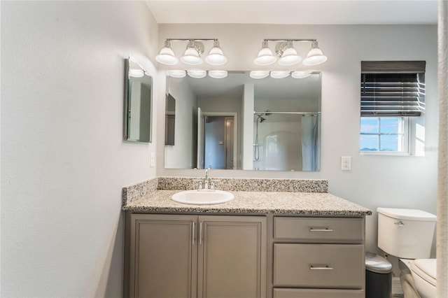 bathroom with vanity, curtained shower, and toilet