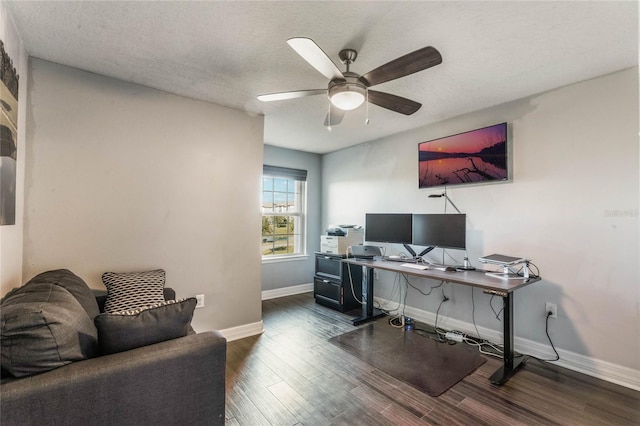 office featuring a textured ceiling, dark wood-type flooring, and ceiling fan