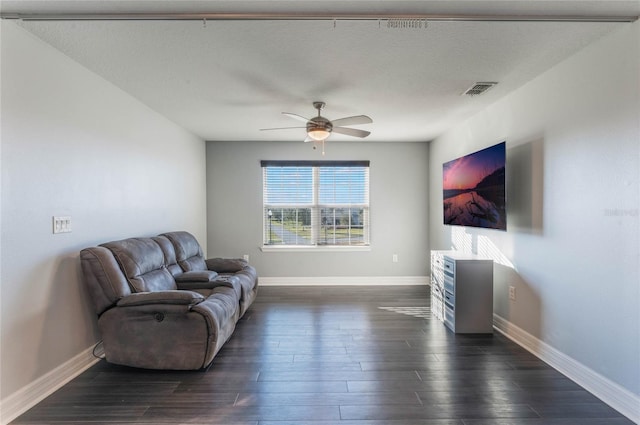 interior space featuring dark hardwood / wood-style flooring, a textured ceiling, and ceiling fan