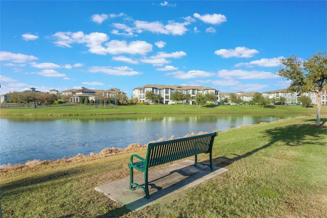 view of home's community featuring a water view and a lawn